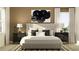 Cozy bedroom featuring a plush bed, stylish bedside tables, decorative lamps, and modern wall art at 9640 Runaway Breeze Dr, Land O Lakes, FL 34637