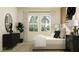 Serene bedroom with a plush bed, bedside lamps, modern dresser, and large windows with natural light at 9640 Runaway Breeze Dr, Land O Lakes, FL 34637