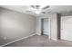 This bedroom features a ceiling fan, closet, and carpeting at 9683 Ashworth Pl, Land O Lakes, FL 34637