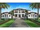 Stunning two-story home features manicured landscaping, symmetrical design, a brick driveway, and balcony at 1 Avonwood, Tampa, FL 33625
