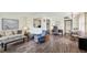Inviting living space featuring wood-look floors, and an open layout to the kitchen at 101 Cambridge Trl # 199, Sun City Center, FL 33573