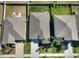 Aerial view showing the roof of a single Gathering home with green grass, nearby properties and neighborhood streets at 10115 Paradise Fish Dr, Riverview, FL 33578