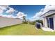 Expansive backyard featuring a privacy fence, lush lawn, and covered grill on a concrete patio perfect for entertaining at 10115 Paradise Fish Dr, Riverview, FL 33578