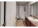 Bathroom features a single sink vanity, tiled floor, and a shower/tub combo with a curtain at 10115 Paradise Fish Dr, Riverview, FL 33578
