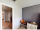 A neat bedroom features a desk, chair, and view of the bathroom at 10115 Paradise Fish Dr, Riverview, FL 33578