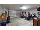 Spacious garage featuring an open overhead door and equipped with home gym equipment and ample storage space at 10115 Paradise Fish Dr, Riverview, FL 33578