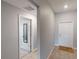 Inviting foyer featuring tile floors, neutral paint, and a doorway leading to another room with a full-length mirror at 10115 Paradise Fish Dr, Riverview, FL 33578