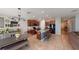 Spacious kitchen featuring a large island with bar seating, dark wood cabinets, stainless steel appliances, and tile flooring at 10115 Paradise Fish Dr, Riverview, FL 33578