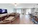 Spacious living area with a comfortable sectional sofa, tile floors, and an open layout connecting to the kitchen and dining area at 10115 Paradise Fish Dr, Riverview, FL 33578