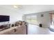 Inviting living room with tile flooring, cozy sectional sofa, and plenty of natural light at 10115 Paradise Fish Dr, Riverview, FL 33578