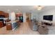 Open floor plan showcasing the kitchen, living room with comfortable seating, and seamless flow throughout the living space at 10115 Paradise Fish Dr, Riverview, FL 33578