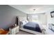 Comfortable main bedroom with neutral tones, a tufted headboard, and plenty of natural light at 10115 Paradise Fish Dr, Riverview, FL 33578