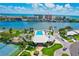 Stunning aerial view of waterfront community with pool, tennis courts, and boat access to bay and ocean at 10215 Regal Dr # 45, Largo, FL 33774