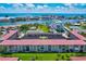 Scenic aerial shot of a condo community near the water, featuring a pool and lush landscaping at 10215 Regal Dr # 45, Largo, FL 33774