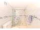 Well-lit bathroom with a glass-enclosed shower and tiled walls and starfish accents at 10215 Regal Dr # 45, Largo, FL 33774