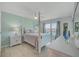 Bedroom with a four-poster bed, soft colors, and natural light at 10215 Regal Dr # 45, Largo, FL 33774