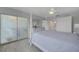 Spacious bedroom with frosted glass closet doors, four-poster bed, and ensuite bathroom access at 10215 Regal Dr # 45, Largo, FL 33774