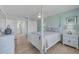 Bedroom with four-poster bed, light walls, and adjacent bathroom access at 10215 Regal Dr # 45, Largo, FL 33774