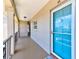 A bright blue front door welcomes you to this condo, complemented by neutral walls and an outdoor hallway at 10215 Regal Dr # 45, Largo, FL 33774