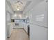 Bright kitchen with white cabinetry, appliances, and a stylish backsplash at 10215 Regal Dr # 45, Largo, FL 33774