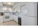 Well-lit kitchen with white cabinetry, modern appliances, and sleek countertops at 10215 Regal Dr # 45, Largo, FL 33774
