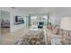 Inviting living room with a cozy sofa, balcony access, and a view into the adjacent bedroom at 10215 Regal Dr # 45, Largo, FL 33774