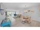 Bright and airy living room with a dining area and sliding glass doors to a balcony at 10215 Regal Dr # 45, Largo, FL 33774