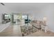 Comfortable living room featuring a plush sofa, accent chairs, and access to a private balcony at 10215 Regal Dr # 45, Largo, FL 33774