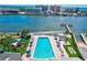 Large pool with lounge chairs and umbrellas surrounded by playground and bayside access at 10215 Regal Dr # 45, Largo, FL 33774