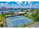 Aerial view of community tennis courts, clubhouse, and surrounding landscaping at 10215 Regal Dr # 45, Largo, FL 33774