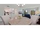 Bright open-concept living area featuring a dining area, kitchen, and balcony access at 10216 Regal Dr # 405, Largo, FL 33774