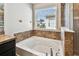 Bright bathroom featuring a soaking tub and glass-enclosed shower at 10222 Newminster Loop, Ruskin, FL 33573