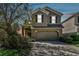 Inviting two-story home featuring a two-car garage and manicured landscaping at 10222 Newminster Loop, Ruskin, FL 33573