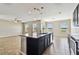 Spacious kitchen with island overlooking the living room area, featuring multiple windows at 10222 Newminster Loop, Ruskin, FL 33573
