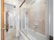 Bright bathroom featuring tiled shower with glass doors and tiled floor at 11601 86Th Ave, Seminole, FL 33772
