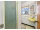 Bathroom with shower and yellow sink and vanity at 11601 86Th Ave, Seminole, FL 33772