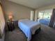 Bedroom with sliding glass doors, carpet, and side table with decorative lamp at 11601 86Th Ave, Seminole, FL 33772
