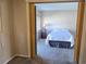 View into a bedroom featuring a simple bed and side table at 11601 86Th Ave, Seminole, FL 33772