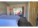 Bedroom features a bed, sliding glass doors leading to the outside patio at 11601 86Th Ave, Seminole, FL 33772