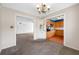 Open dining room featuring a vintage chandelier, views into the kitchen, and built-in storage at 11601 86Th Ave, Seminole, FL 33772