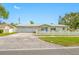 Charming home with a white picket fence, neat landscaping, and a spacious driveway leading to an attached garage at 11601 86Th Ave, Seminole, FL 33772