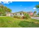 Well-manicured lawn and landscaping with a partial view of the house, including its tidy yard at 11601 86Th Ave, Seminole, FL 33772