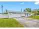 Home with an attached garage, featuring a well-manicured lawn and a neatly paved driveway on a sunny day at 11601 86Th Ave, Seminole, FL 33772
