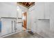 Unfinished garage with door to a bathroom area, offering lots of potential for upgrades and customization at 11601 86Th Ave, Seminole, FL 33772