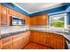Beautiful kitchen with granite countertops, wood cabinetry, stainless steel sink, and modern appliances at 11601 86Th Ave, Seminole, FL 33772