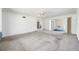 Spacious living room with gray carpeting and a ceiling fan; doorway to bathroom at 11601 86Th Ave, Seminole, FL 33772