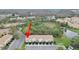 Aerial view of the townhome row nestled amongst natural surroundings at 1256 Redondo Way, Wesley Chapel, FL 33543