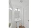 Clean, pedestal sink in bathroom with decorative light fixture and neutral color scheme at 1256 Redondo Way, Wesley Chapel, FL 33543