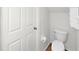 Small toilet next to the door inside a minimalistic yet very tidy bathroom at 1256 Redondo Way, Wesley Chapel, FL 33543