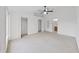 Bright bedroom with ceiling fan, two closets, and an ensuite bathroom at 1256 Redondo Way, Wesley Chapel, FL 33543
